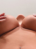 Nikki poses in her bare feet with tons of smiles and a great view of her massive boobs