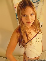 Teen spreads her legs to show off her panties