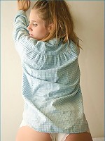 laying in bed in a baby blue shirt
