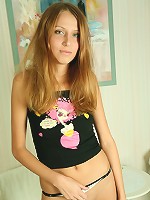 Cute teen takes off her clothes and spreads her long legs