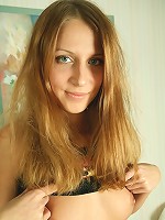 Cute teen takes off her clothes and spreads her long legs