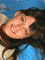 Cute brunette teen undressing on the bed