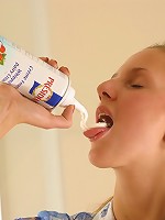 Innocent looking girl spreads whipped cream all over her naked body