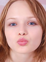 Very beautiful blond girl strips and spreads on the bed