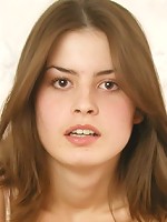 Lovely teen girl posing naked on the bed