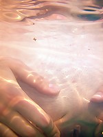 Two lesbian teens in a small pool