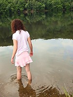 Chick washing herself in a river
