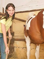 Cute teenager strips in a stable