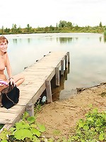Teen near a lake pleasures cooch