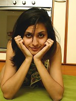 Girl gets naked and plays with her pussy in the kitchen