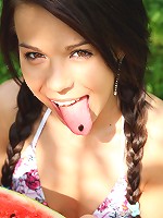 Sweet and naked teen laying on the ground outdoors