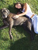 Naughty teen Kiki posing with huge dog outdoors