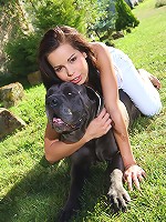 Sexy brunette teen plays with her cane corso