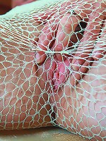 Little Caprice masturbating through fishnet pantyhose